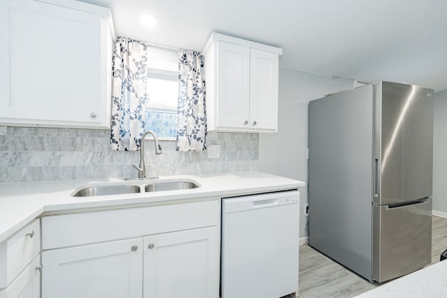 309 James St, Terrell, TX 75160 - kitchen with freestanding refrigerator, dishwasher, a sink, and white cabinets