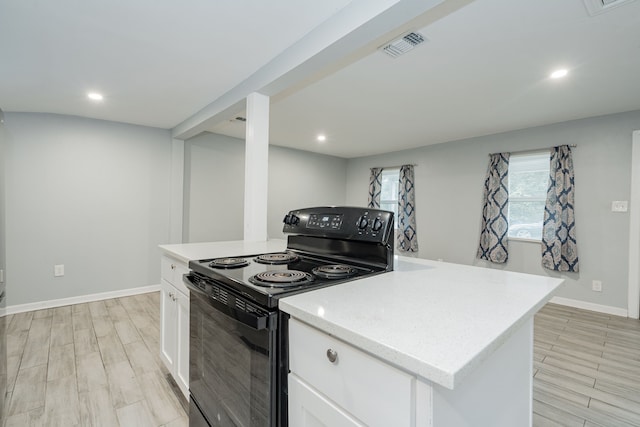 309 James St, Terrell, TX 75160 - kitchen featuring black / electric stove, white cabinetry, recessed lighting, and light wood-type flooring