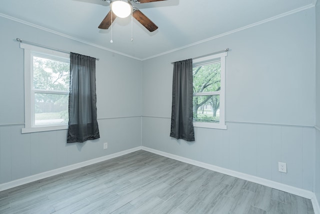 309 James St, Terrell, TX 75160 - unfurnished room featuring wood finished floors, ornamental molding, ceiling fan, wainscoting, and baseboards