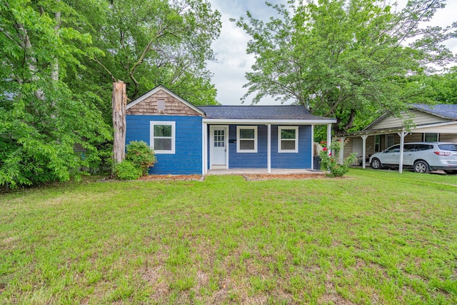 309 James St, Terrell, TX 75160 - view of front of house with a porch, a front yard, a chimney, and a shingled roof