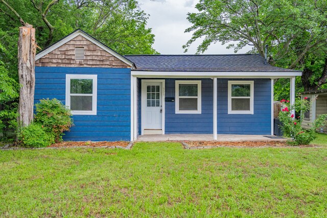309 James St, Terrell, TX 75160 - view of front of property featuring a porch, a front yard, and a shingled roof