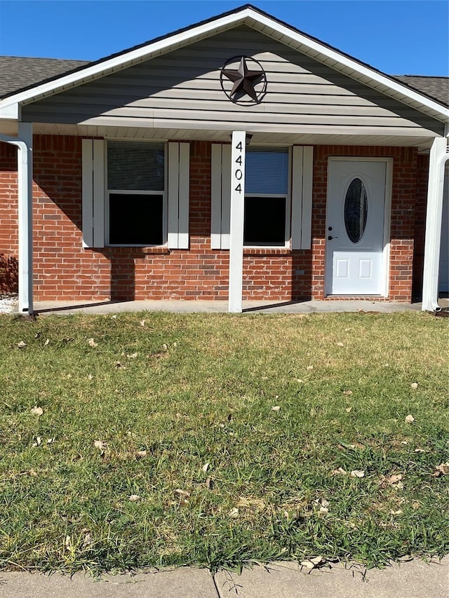 4404 Bobbie Ann Dr, Granbury, TX 76049 - view of front facade with brick siding, a front yard, and roof with shingles