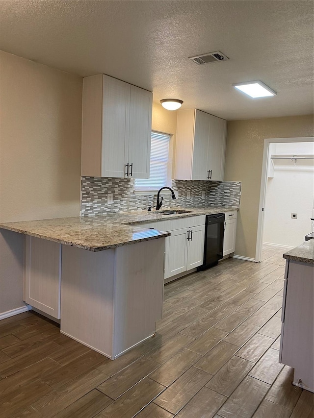 4404 Bobbie Ann Dr, Granbury, TX 76049 - kitchen with a sink, dishwasher, dark wood-style flooring, tasteful backsplash, and a textured ceiling