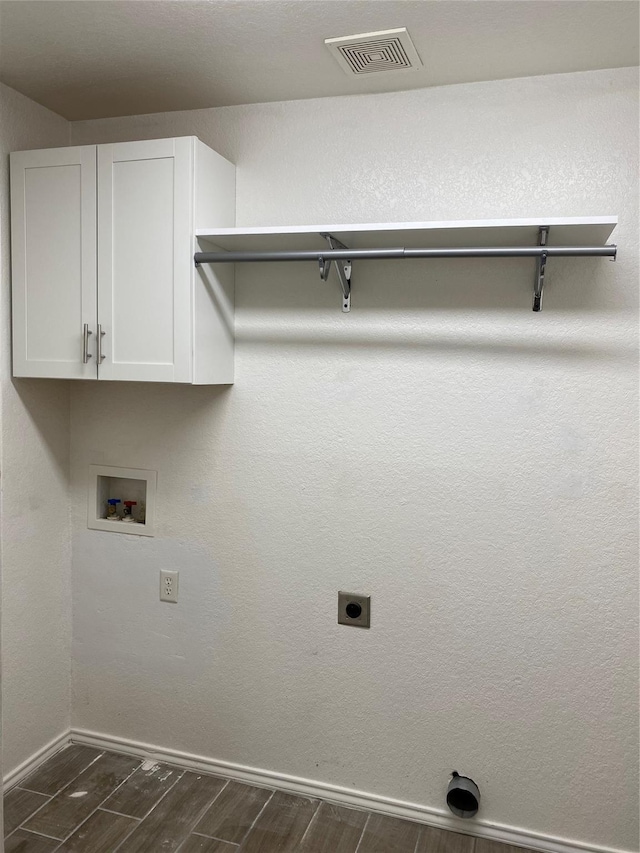 4404 Bobbie Ann Dr, Granbury, TX 76049 - laundry area with washer hookup, baseboards, cabinet space, hookup for an electric dryer, and dark wood finished floors