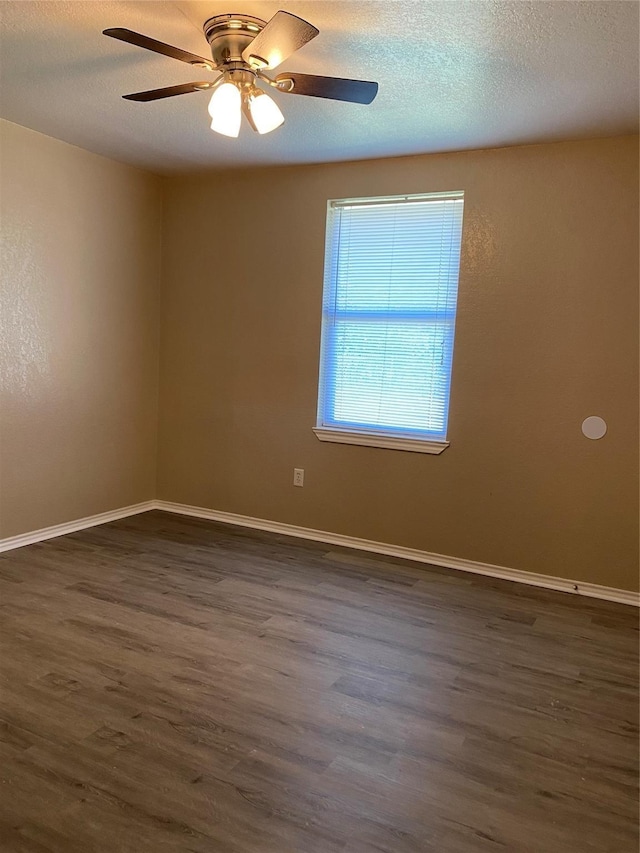 4404 Bobbie Ann Dr, Granbury, TX 76049 - unfurnished room featuring dark wood finished floors, ceiling fan, baseboards, and a textured ceiling