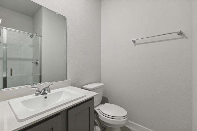 bathroom with vanity, toilet, and a shower stall