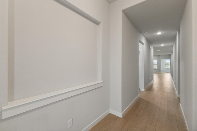 hall featuring recessed lighting, baseboards, and hardwood / wood-style flooring