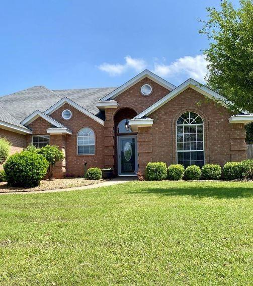 615 Parker Ln, Granbury, TX 76048 - view of front facade with a front lawn, a shingled roof, and brick siding
