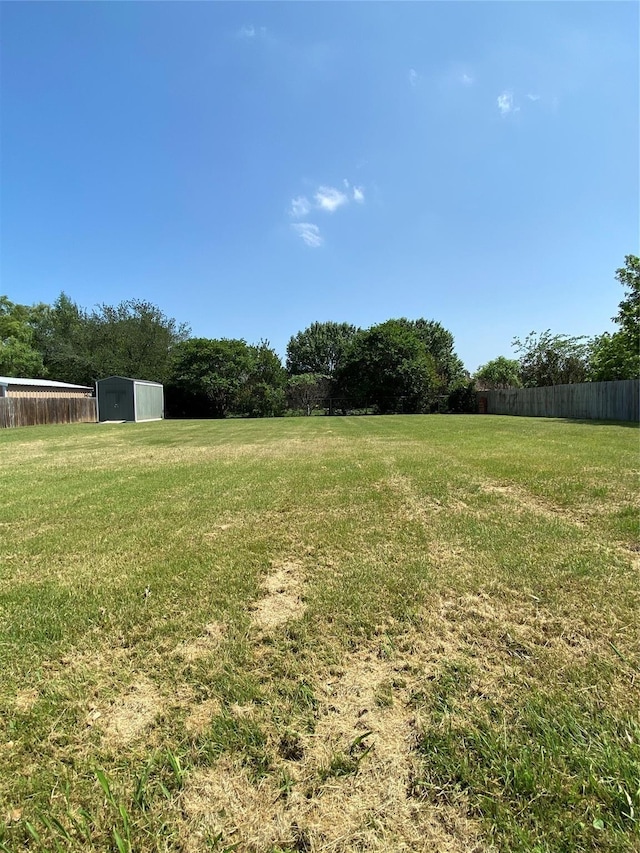 615 Parker Ln, Granbury, TX 76048 - view of yard featuring fence, a storage shed, and an outbuilding
