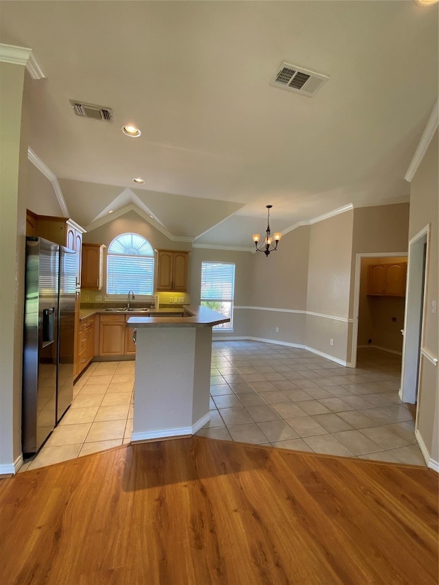 615 Parker Ln, Granbury, TX 76048 - kitchen with light tile patterned floors, stainless steel fridge, a notable chandelier, crown molding, and visible vents
