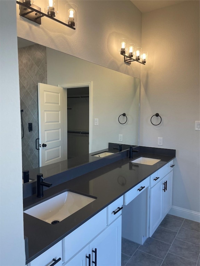 6141 Rodin Dr, Royse City, TX 75189 - full bathroom featuring double vanity, tile patterned floors, baseboards, and tiled shower