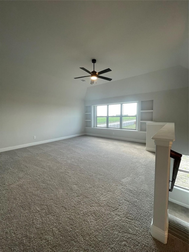 6141 Rodin Dr, Royse City, TX 75189 - unfurnished room with carpet flooring, a ceiling fan, baseboards, lofted ceiling, and built in shelves