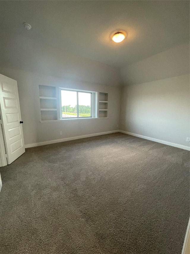 6141 Rodin Dr, Royse City, TX 75189 - empty room featuring built in features, baseboards, and dark carpet