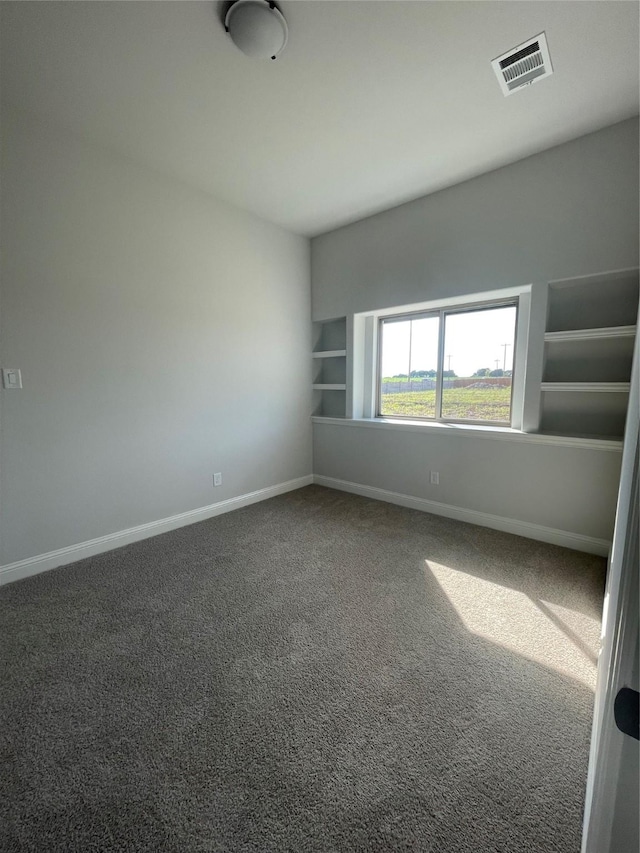 6141 Rodin Dr, Royse City, TX 75189 - unfurnished room with baseboards, carpet floors, and built in shelves