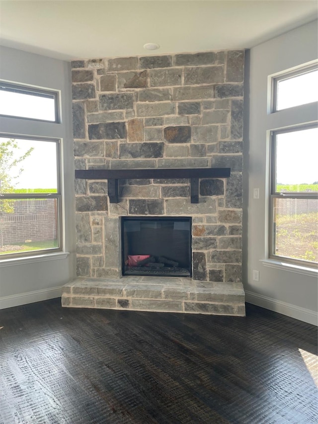 6141 Rodin Dr, Royse City, TX 75189 - detailed view of a stone fireplace, baseboards, and wood finished floors