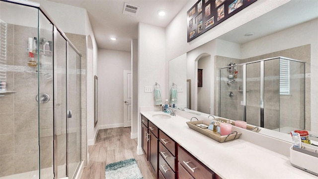 6216 Brunswick Dr, Celina, TX 76227 - full bath featuring wood finished floors, vanity, visible vents, a stall shower, and baseboards