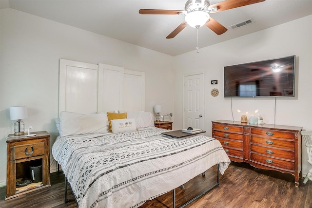 bedroom with ceiling fan, visible vents, and wood finished floors