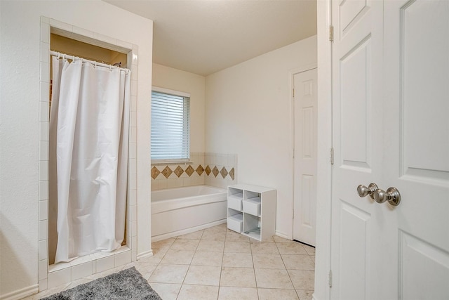 full bathroom with a garden tub, a shower stall, baseboards, and tile patterned floors