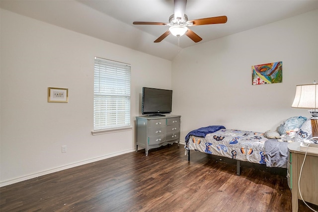bedroom featuring vaulted ceiling, baseboards, a ceiling fan, and wood finished floors