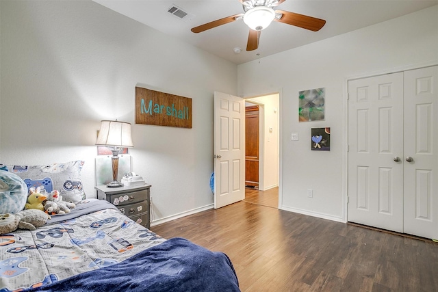 bedroom with a ceiling fan, visible vents, wood finished floors, and baseboards