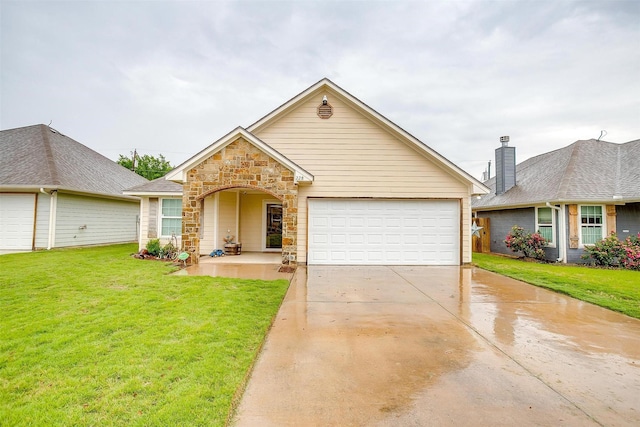 view of front facade with a front lawn, driveway, an attached garage, and stone siding