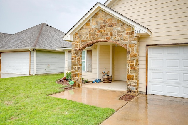property entrance featuring stone siding, concrete driveway, a lawn, and a garage