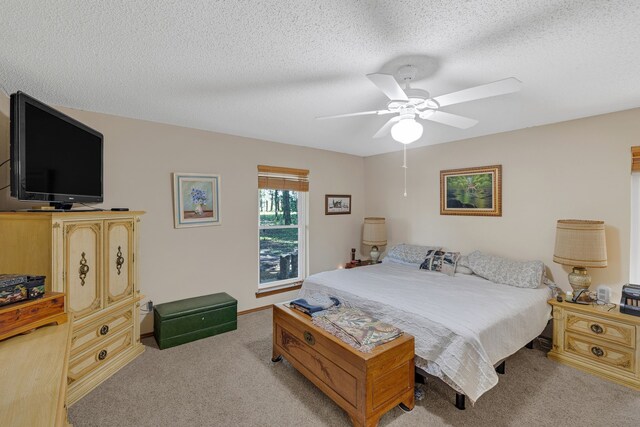 906 County Road 2770, Honey Grove, TX 75446 - bedroom featuring light colored carpet, a textured ceiling, and a ceiling fan