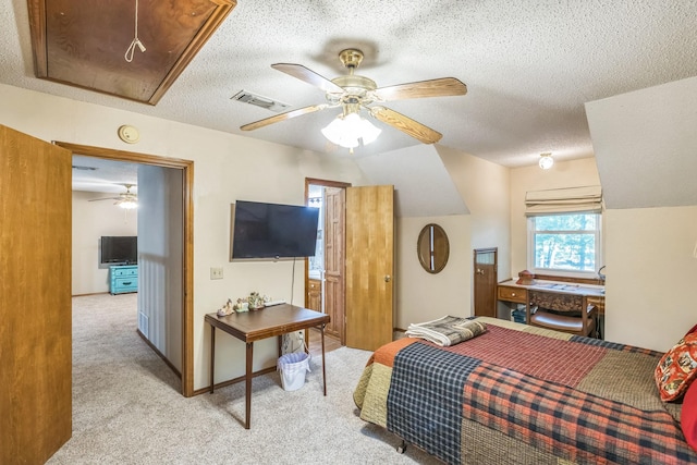 906 County Road 2770, Honey Grove, TX 75446 - carpeted bedroom featuring ceiling fan, visible vents, attic access, and a textured ceiling