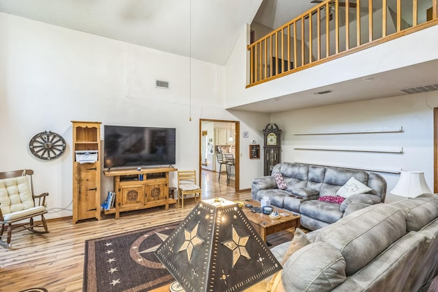 906 County Road 2770, Honey Grove, TX 75446 - living room with visible vents, wood finished floors, baseboards, and high vaulted ceiling