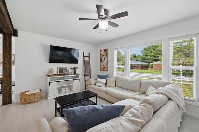 1718 Heather Rd, Gainesville, TX 76240 - living area featuring plenty of natural light, ceiling fan, light wood-style floors, and baseboards
