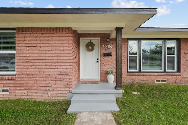 1718 Heather Rd, Gainesville, TX 76240 - view of exterior entry featuring brick siding and a yard