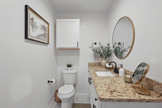 1718 Heather Rd, Gainesville, TX 76240 - bathroom with baseboards, tile patterned flooring, toilet, and vanity