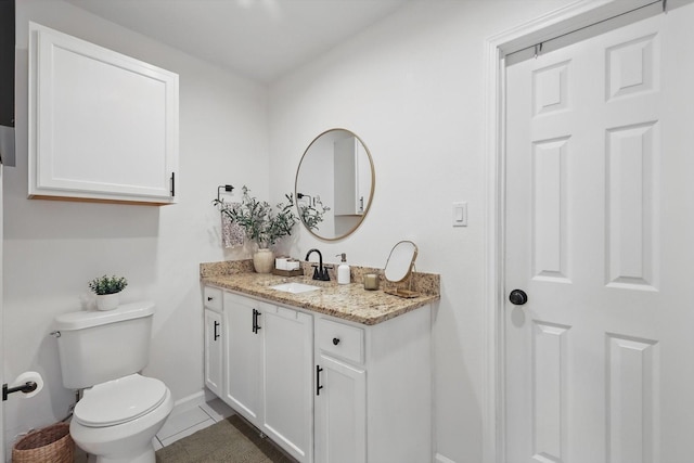 1718 Heather Rd, Gainesville, TX 76240 - bathroom featuring baseboards, tile patterned flooring, vanity, and toilet