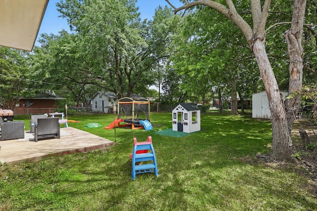 1718 Heather Rd, Gainesville, TX 76240 - view of yard featuring a shed, a patio area, an outbuilding, and a playground