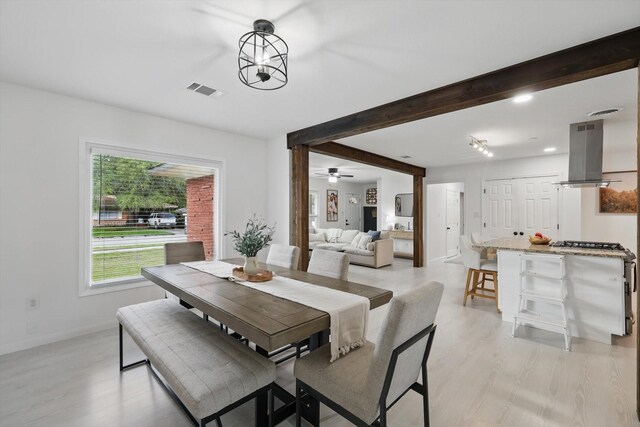 1718 Heather Rd, Gainesville, TX 76240 - dining room with light wood-style floors, beam ceiling, baseboards, and ceiling fan