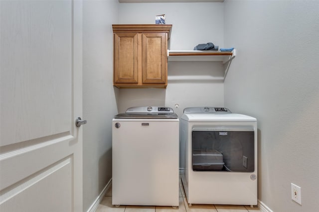 6844 Massa Ln, Frisco, TX 75034 - clothes washing area featuring washing machine and clothes dryer, baseboards, light tile patterned floors, and cabinet space