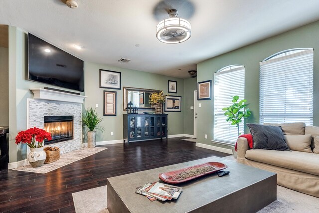6844 Massa Ln, Frisco, TX 75034 - living room featuring baseboards, a stone fireplace, visible vents, and wood finished floors