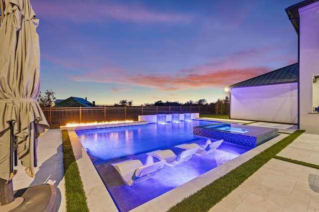 3650 Balfour Ct, Frisco, TX 75034 - pool at dusk with a fenced backyard, a pool with connected hot tub, a patio area, and an outdoor fire pit