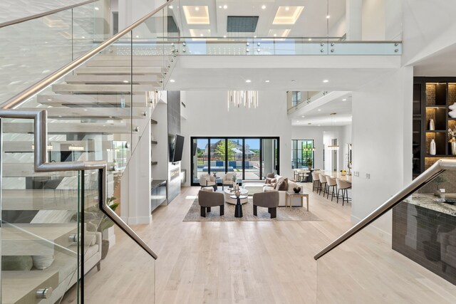 3650 Balfour Ct, Frisco, TX 75034 - living room with a towering ceiling, wood finished floors, stairway, and recessed lighting