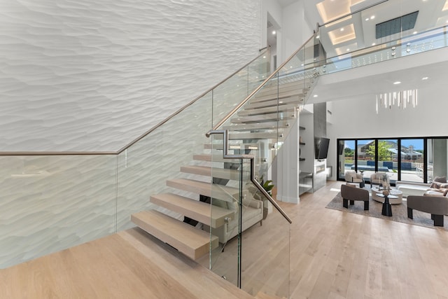 3650 Balfour Ct, Frisco, TX 75034 - stairs with a towering ceiling, wood finished floors, and recessed lighting