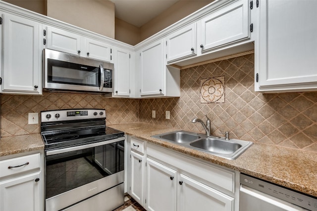 kitchen with white cabinetry, light countertops, appliances with stainless steel finishes, and a sink
