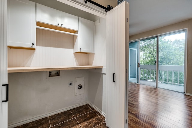 clothes washing area featuring cabinet space, hookup for an electric dryer, washer hookup, and baseboards