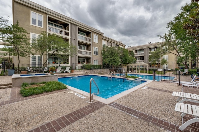 community pool with fence and a patio