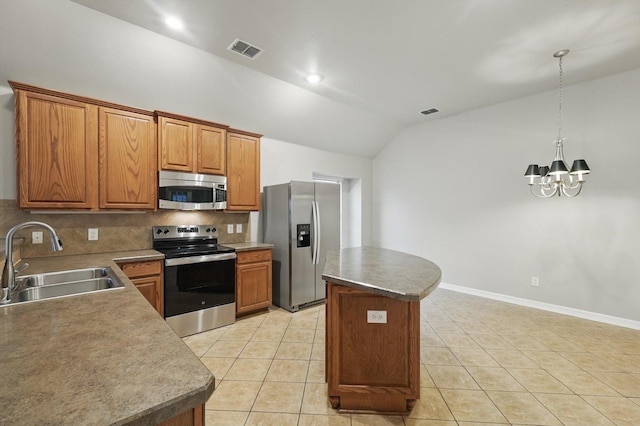 kitchen with decorative backsplash, a sink, visible vents, appliances with stainless steel finishes, and vaulted ceiling