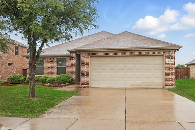 ranch-style home featuring a front lawn, brick siding, and driveway