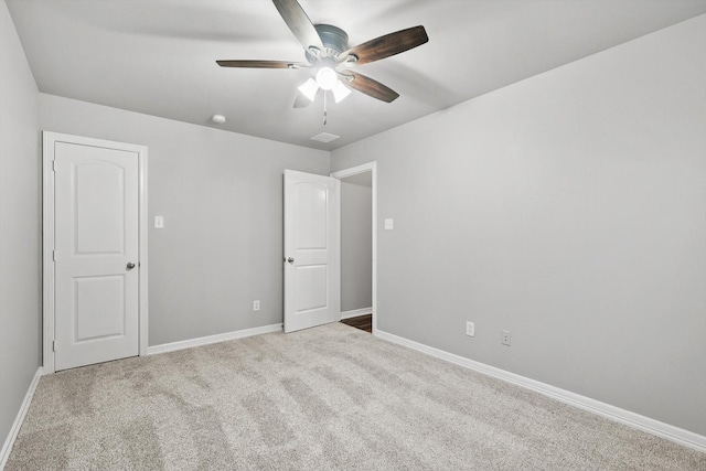unfurnished bedroom with baseboards, ceiling fan, and carpet