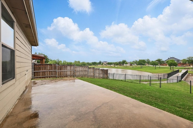 exterior space featuring a water view and a fenced backyard