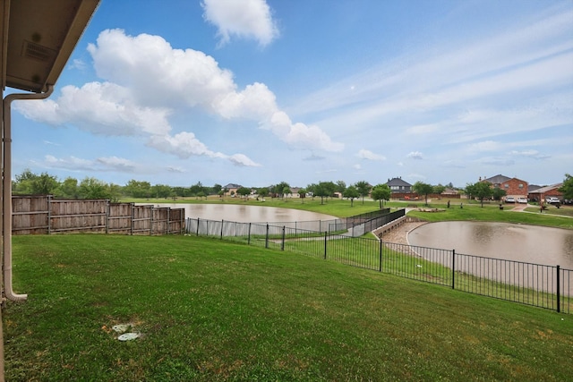 view of yard with fence and a water view