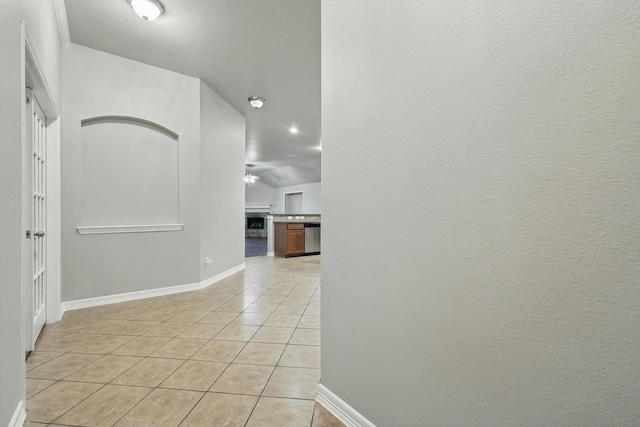 corridor featuring baseboards, recessed lighting, and light tile patterned flooring