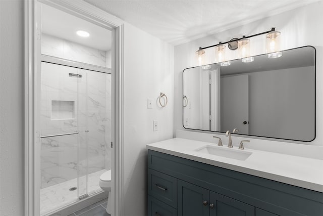 full bathroom featuring toilet, vanity, and a marble finish shower